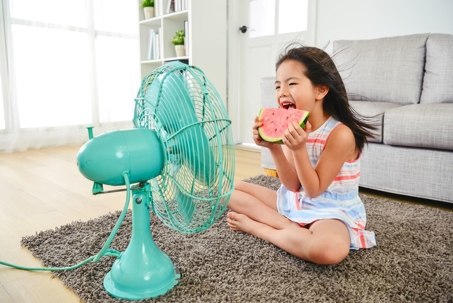 Kid in front of a fan