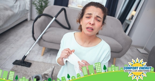 women sneezing while cleaning house